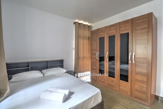 Spacious traditional triplex apartment in Grand Baie with 2 bedrooms, furnished, air conditioning, veranda, and close...