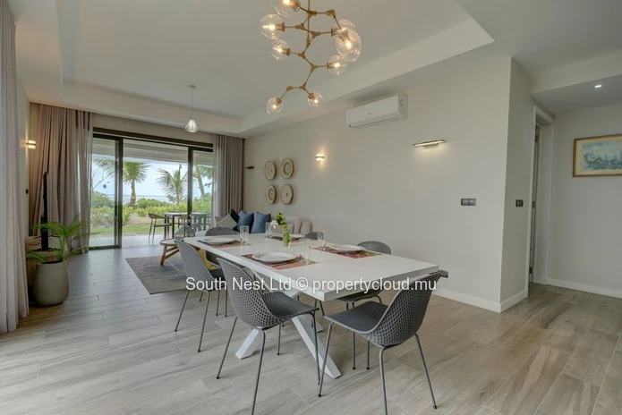 Elegant beachfront 3-bedroom apartment with private garden & direct beach access. 