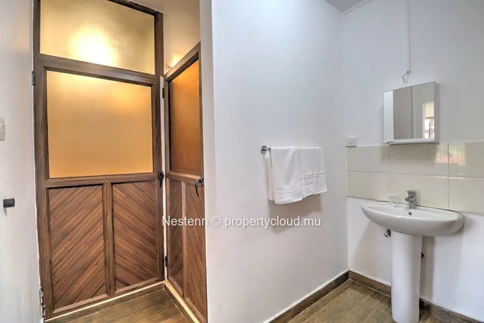 Spacious traditional triplex apartment in Grand Baie with 2 bedrooms, furnished, air conditioning, veranda, and close...