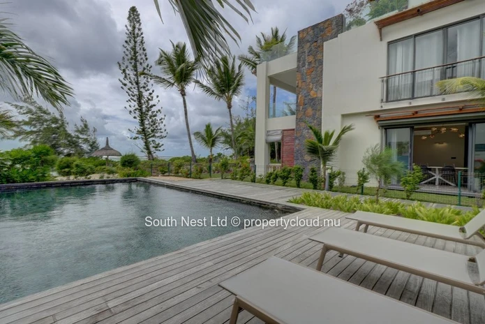 Elegant beachfront 3-bedroom apartment with private garden & direct beach access. 