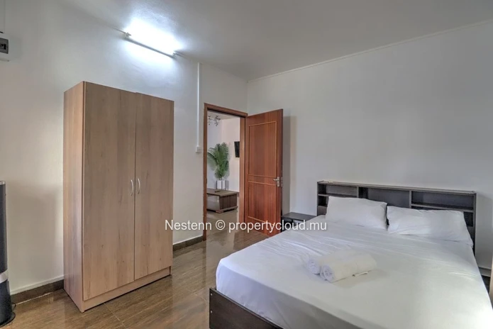 Spacious traditional triplex apartment in Grand Baie with 2 bedrooms, furnished, air conditioning, veranda, and close...