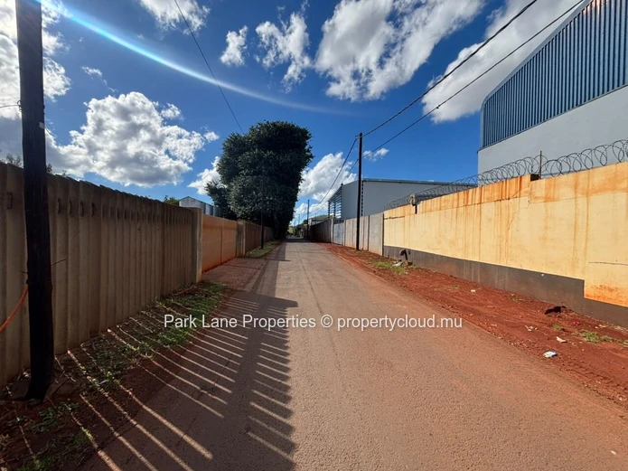 Expansive 8,847 m² Secured Plot with Building and Asphalted Area