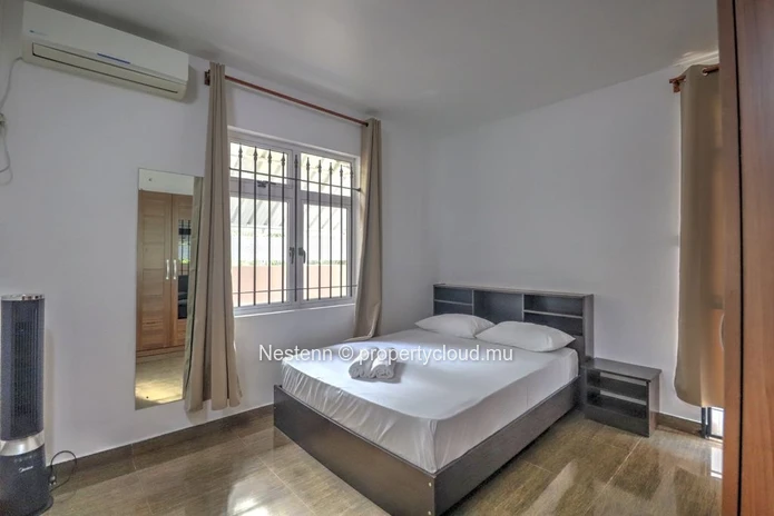 Spacious traditional triplex apartment in Grand Baie with 2 bedrooms, furnished, air conditioning, veranda, and close...