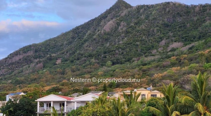 Commercial building with sea and mountain views.