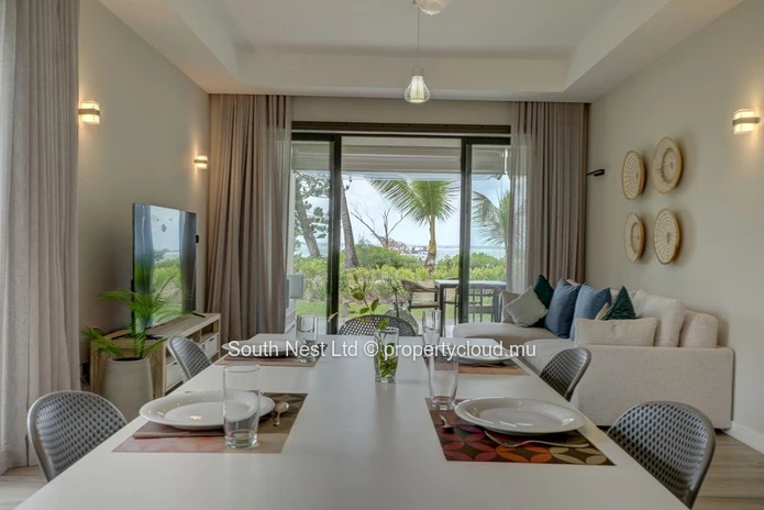 Elegant beachfront 3-bedroom apartment with private garden & direct beach access. 