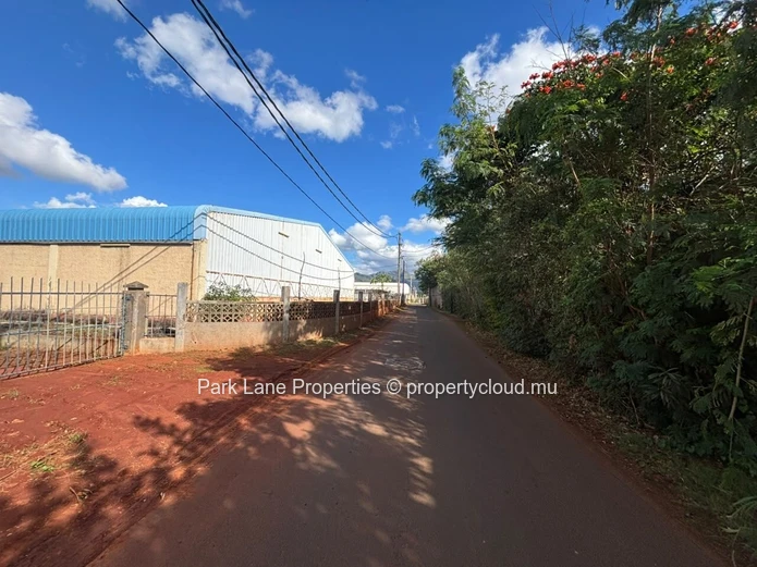 Expansive 8,847 m² Secured Plot with Building and Asphalted Area