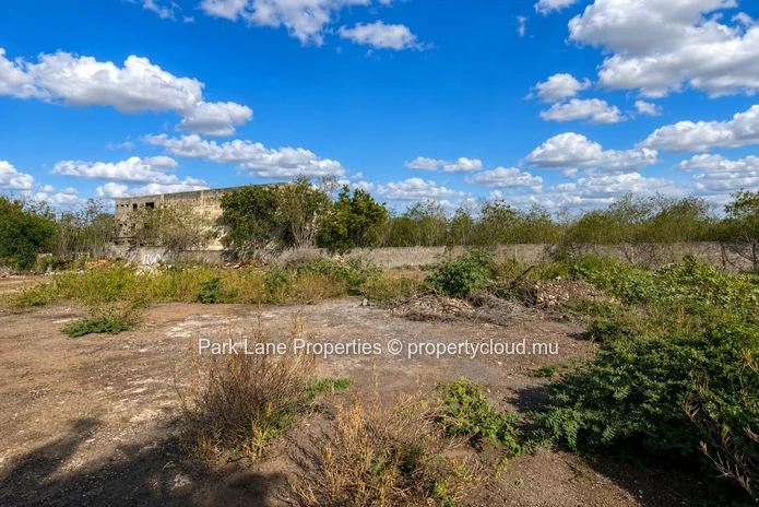 Expansive 8,847 m² Secured Plot with Building and Asphalted Area