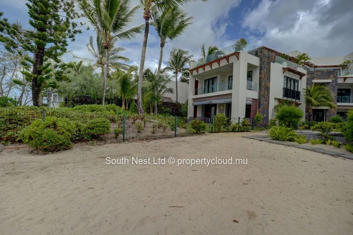 Elegant beachfront 3-bedroom apartment with private garden & direct beach access. 