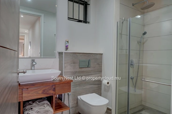 Elegant beachfront 3-bedroom apartment with private garden & direct beach access. 