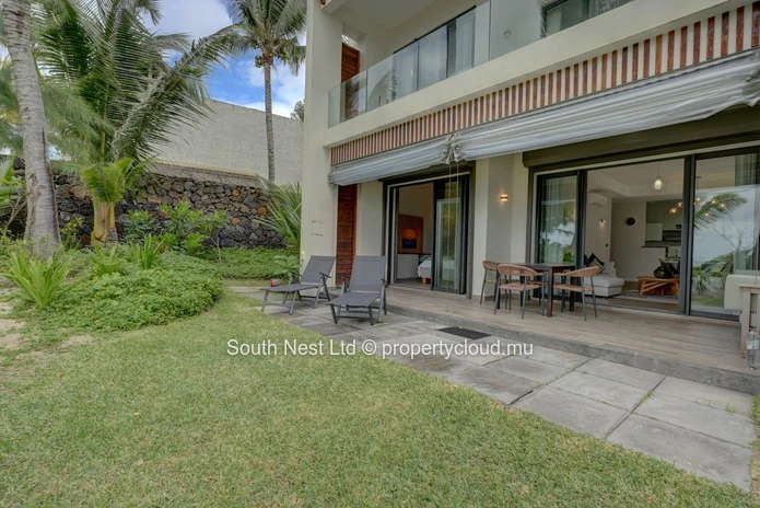 Elegant beachfront 3-bedroom apartment with private garden & direct beach access. 