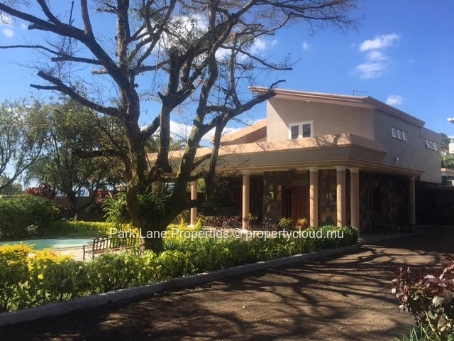 Double-storey home overlooking a magnificent pool and mature trees in Floreal