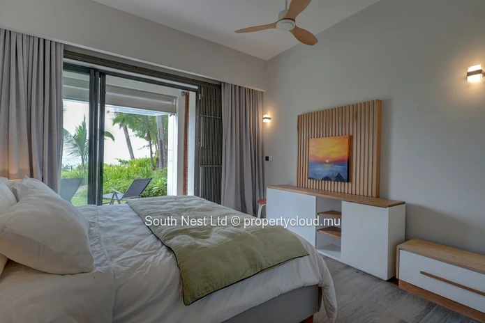 Elegant beachfront 3-bedroom apartment with private garden & direct beach access. 